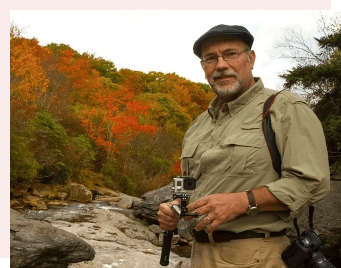 A man holding a camera in his hand.