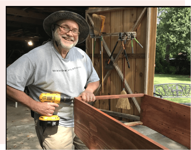 A man holding a drill in his hand.